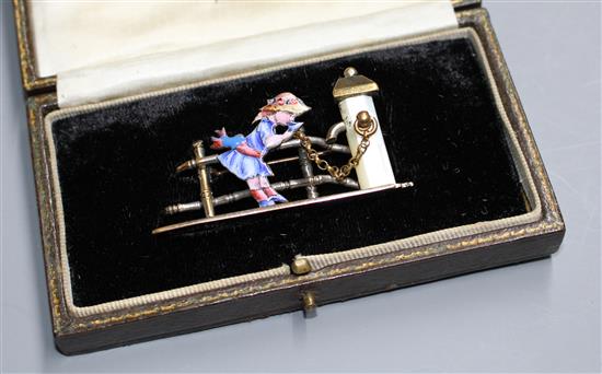 An early 20th century mixed metal, enamel and mother of pearl set Kate Greenaway brooch, in fitted box,